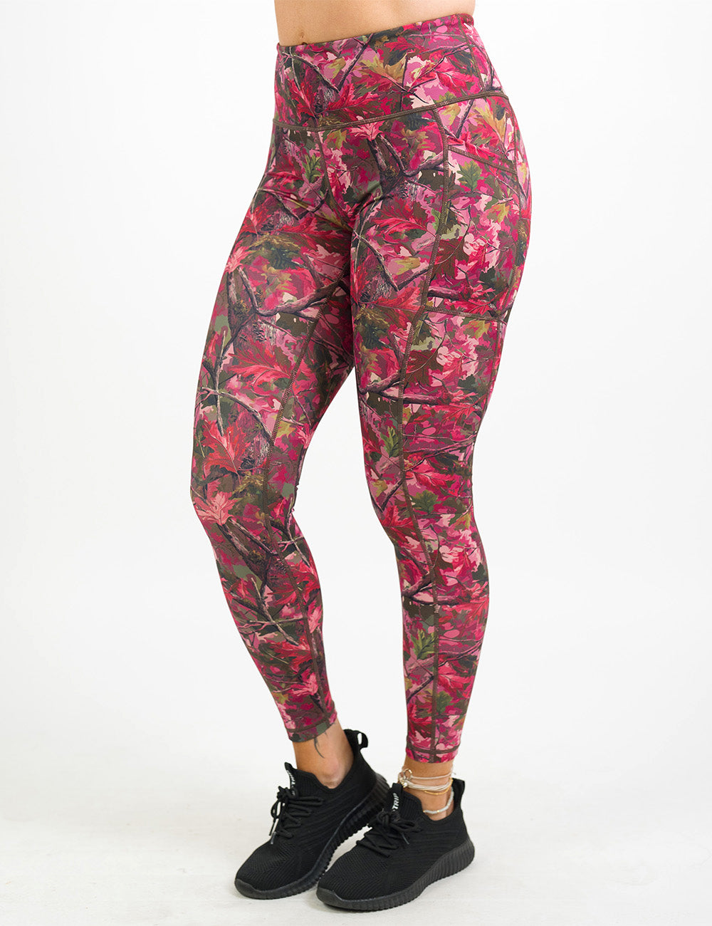front of the full length pink forest camo leggings against a white background