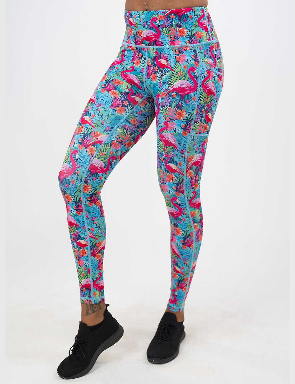 model wearing the full length colorful flamingo leggings against a white background