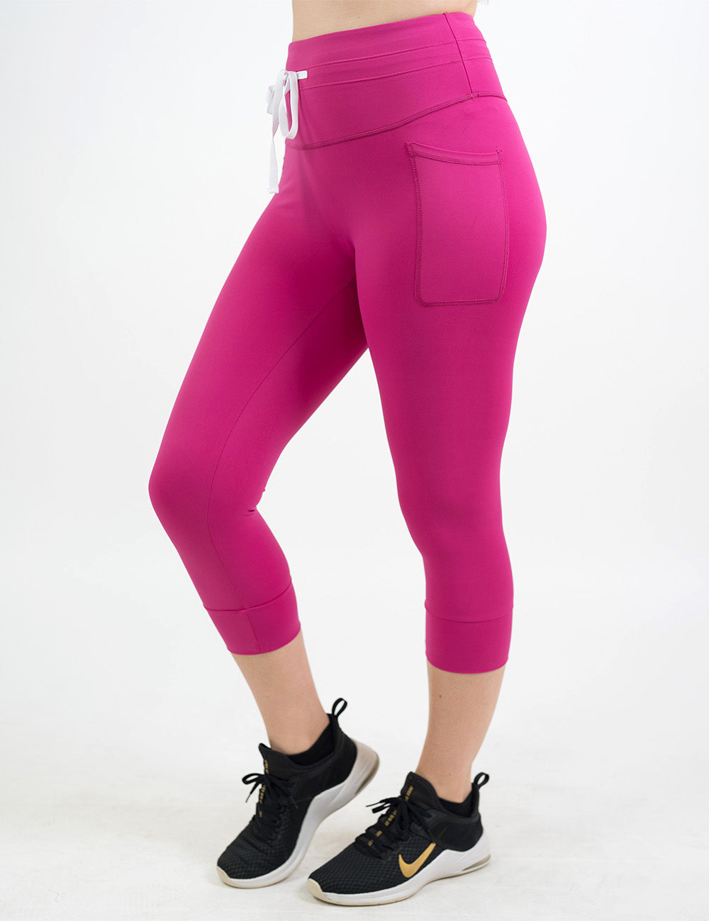front of the capri pink omni style leggings against a white background