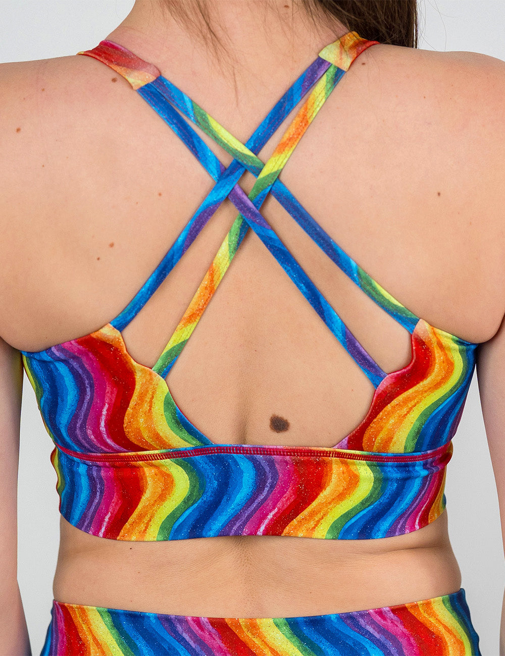 back of the rainbow waves longline bra against a white background