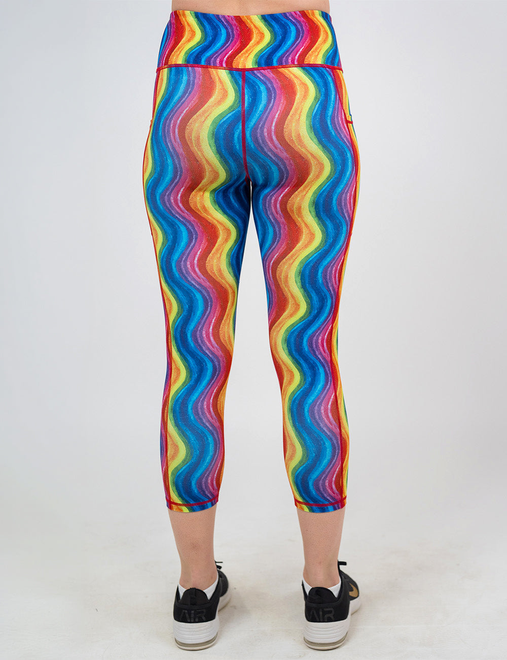 back of the capri rainbow waves leggings against a white background