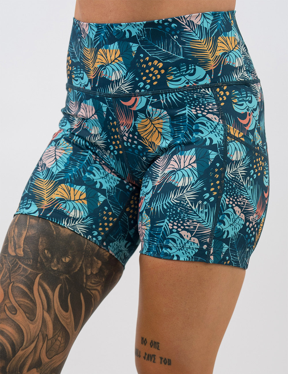 front of the 5 inch blue, pink, yellow, and red tropical leaves shorts against a white background