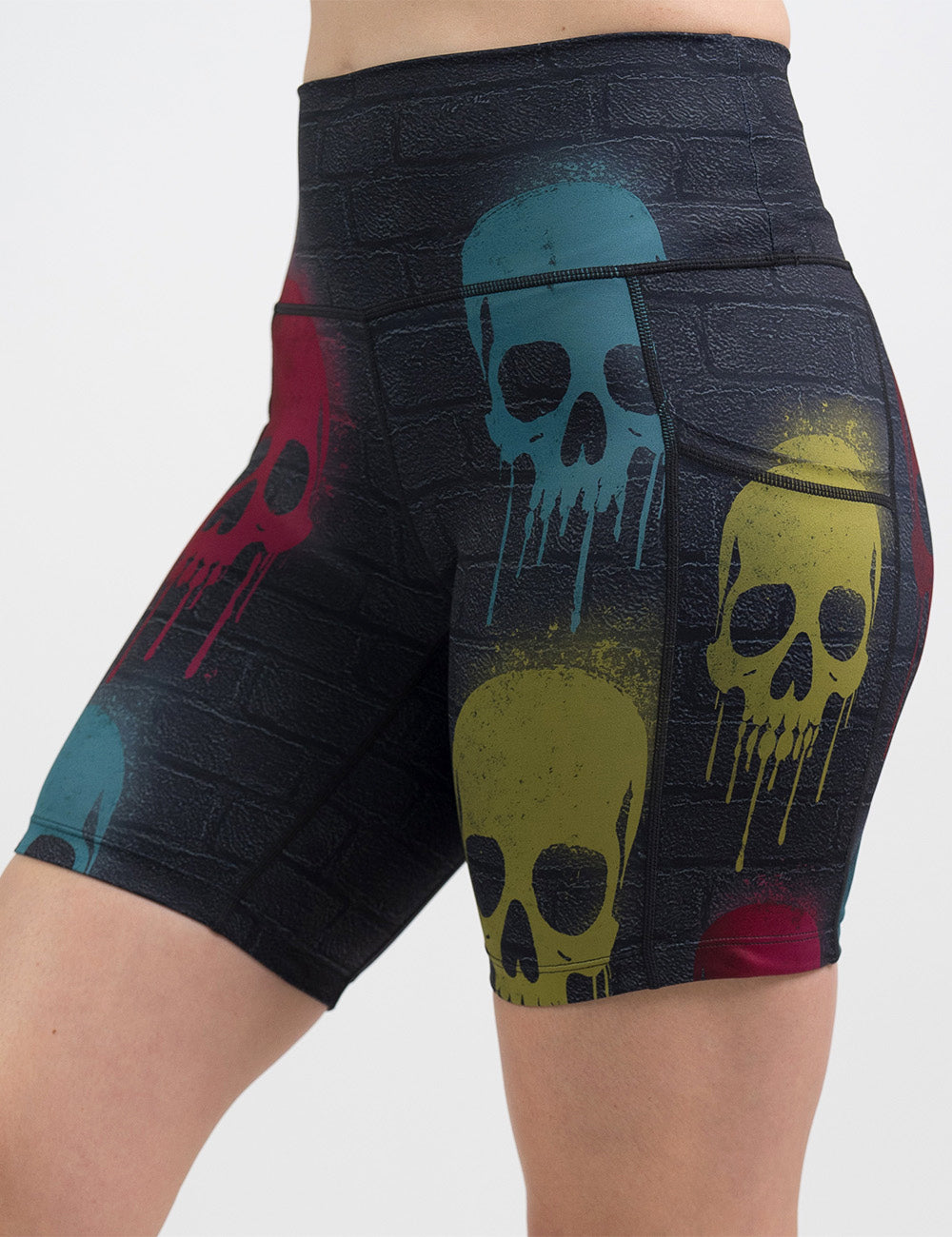 front of the 7 inch black brick pattern with blue, red, and yellow skull spray paint patterns shorts against a white background