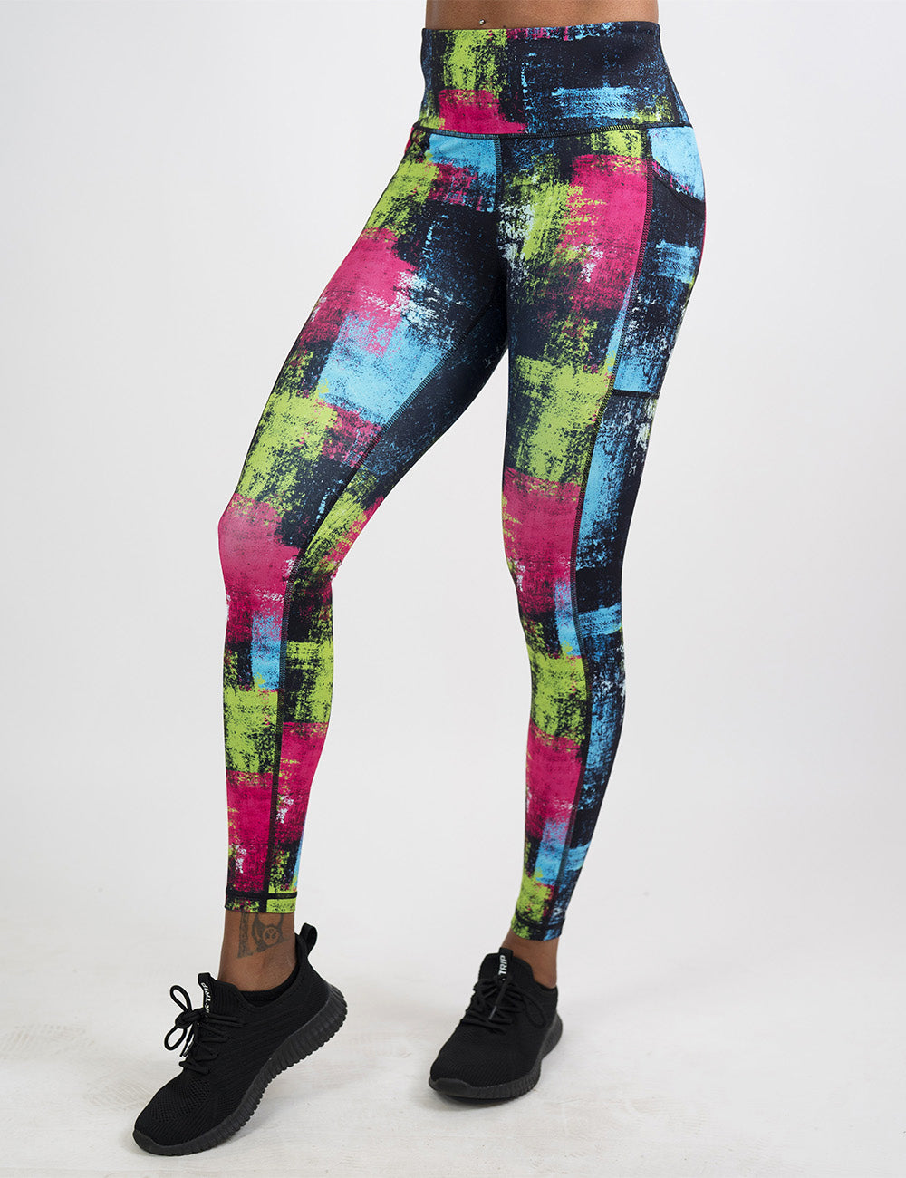 front of the green, pink, and blue grunge pattern full length leggings against a white background