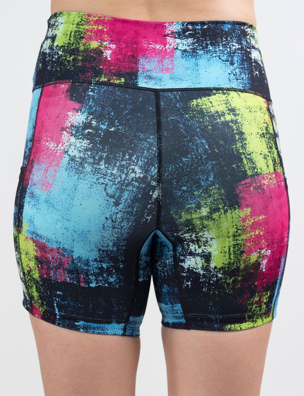 back of the green, pink, and blue grunge pattern 5 inch shorts against a white background