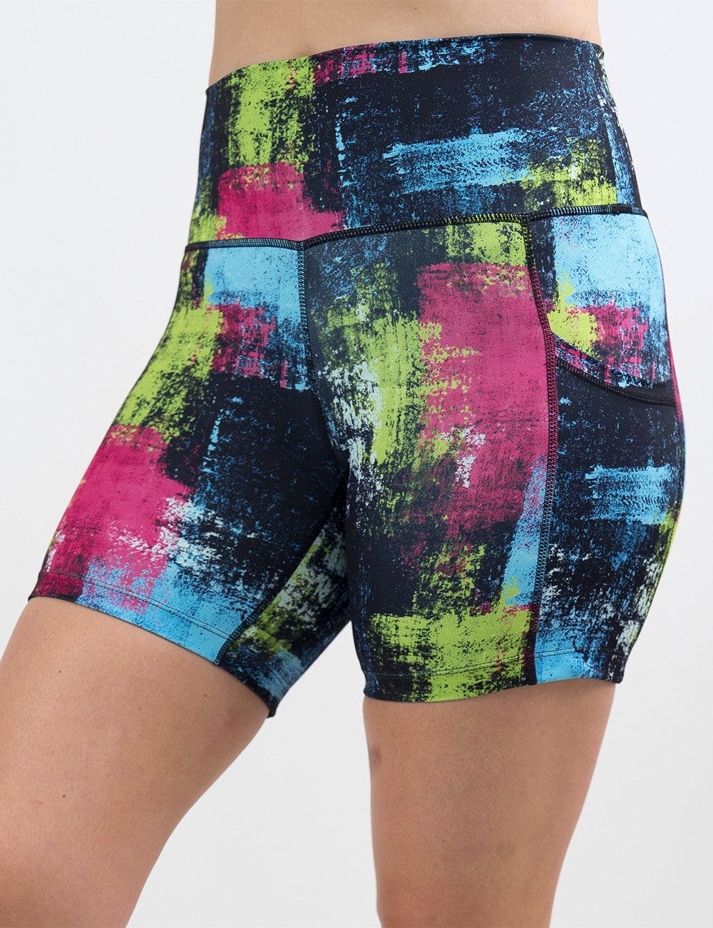 front of the green, pink, and blue grunge pattern 5 inch shorts against a white background