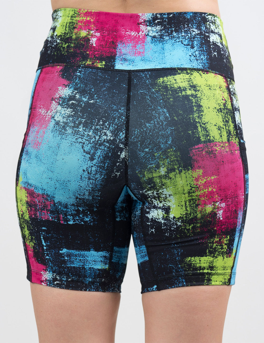 back of the green, pink, and blue grunge pattern 7 inch shorts against a white background
