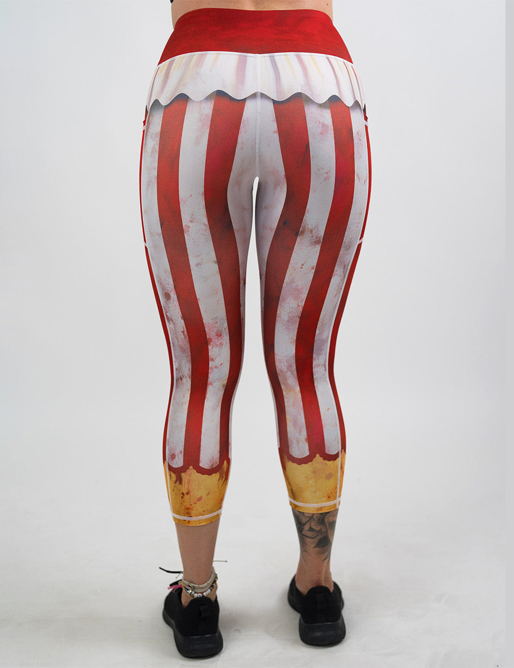 back of the bloody red and white stripes circus capri leggings against a white background