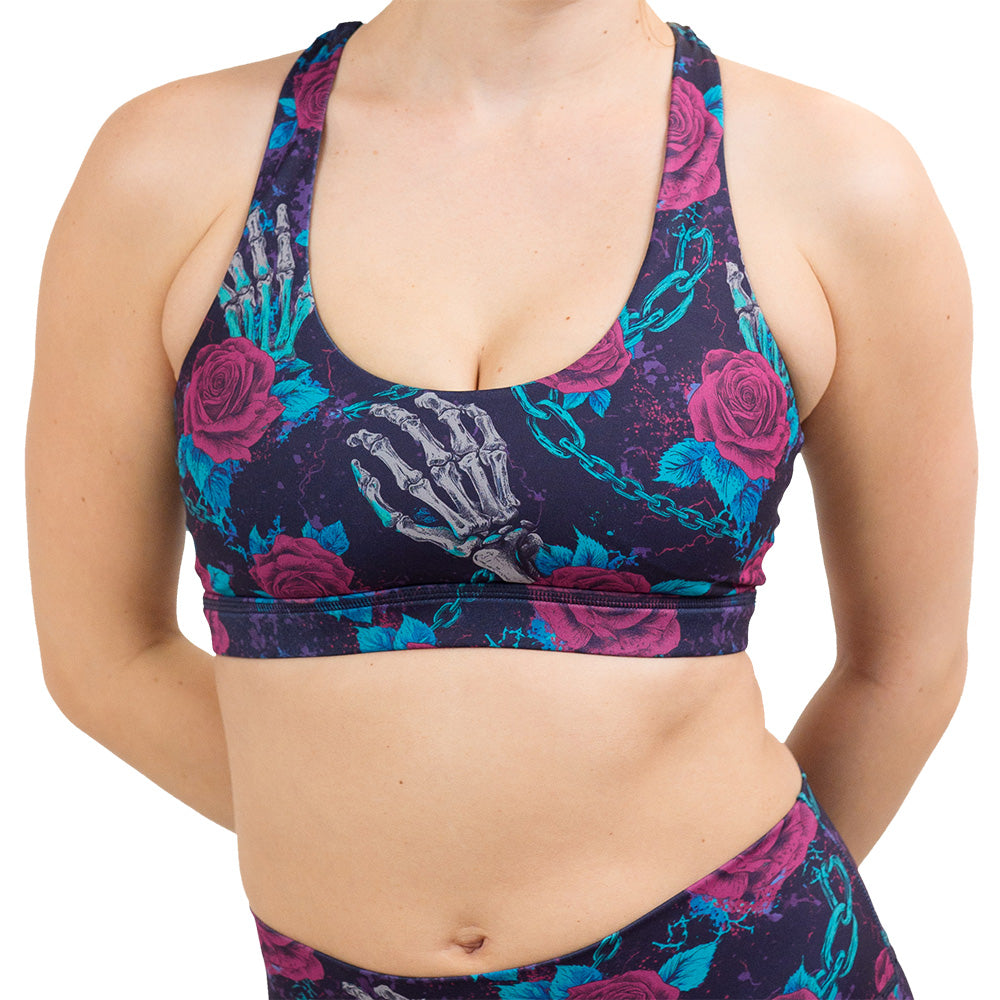 front of the roses and skeleton hands connected by chain links pattern bra against a white background