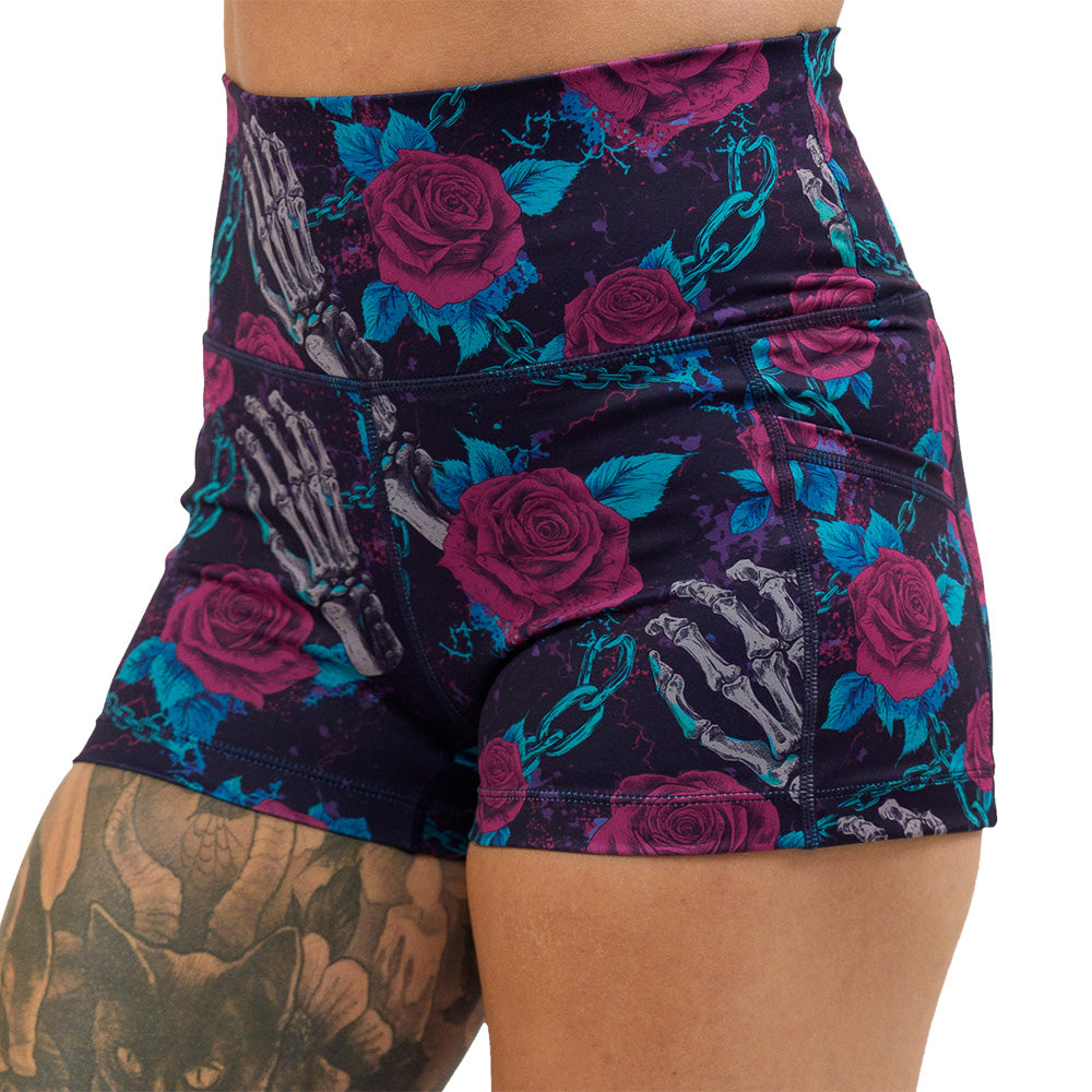 close up of the roses and skeleton hands connected by chain links pattern 2.5 inch shorts against a white background