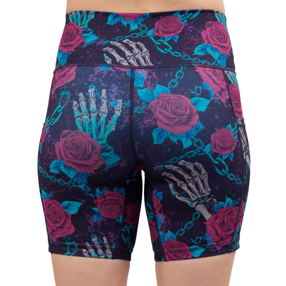 back of the 7 inch roses and skeleton hands connected by chain links pattern shorts against a white background