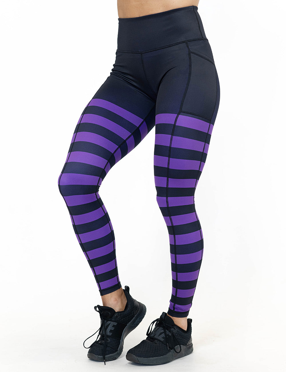 front of the black with purple horizontal stripes full length leggings against a white background