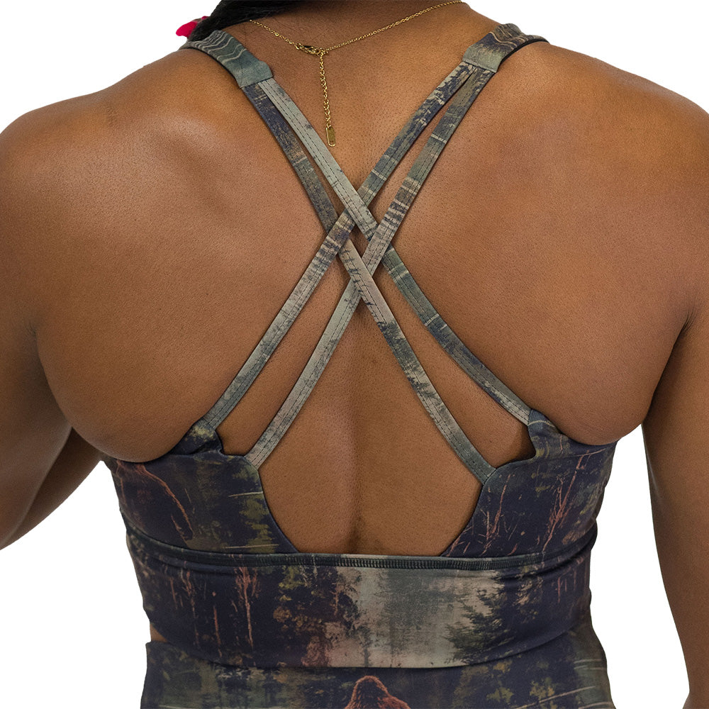 back of the bra with a forest design and a bigfoot graphic on it