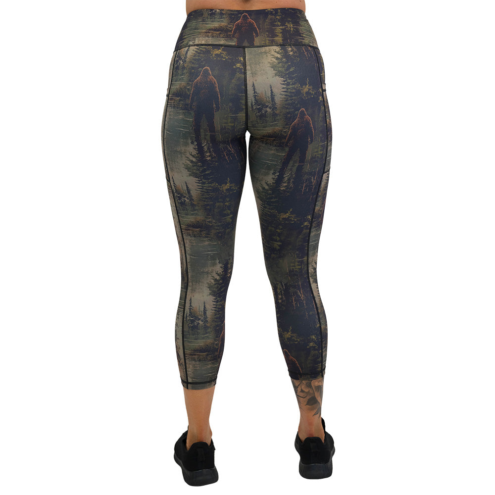 back of the leggings with a forest design and a bigfoot graphic on it