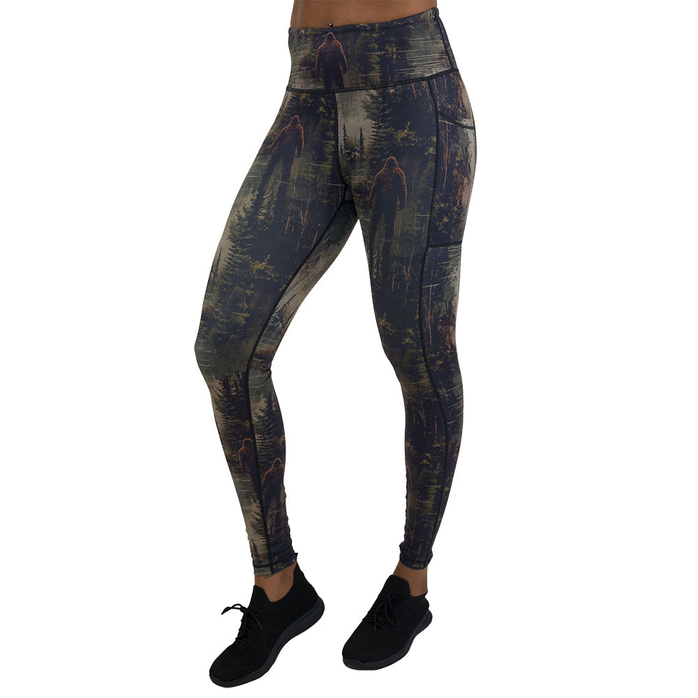 leggings with a forest design and a bigfoot graphic on it
