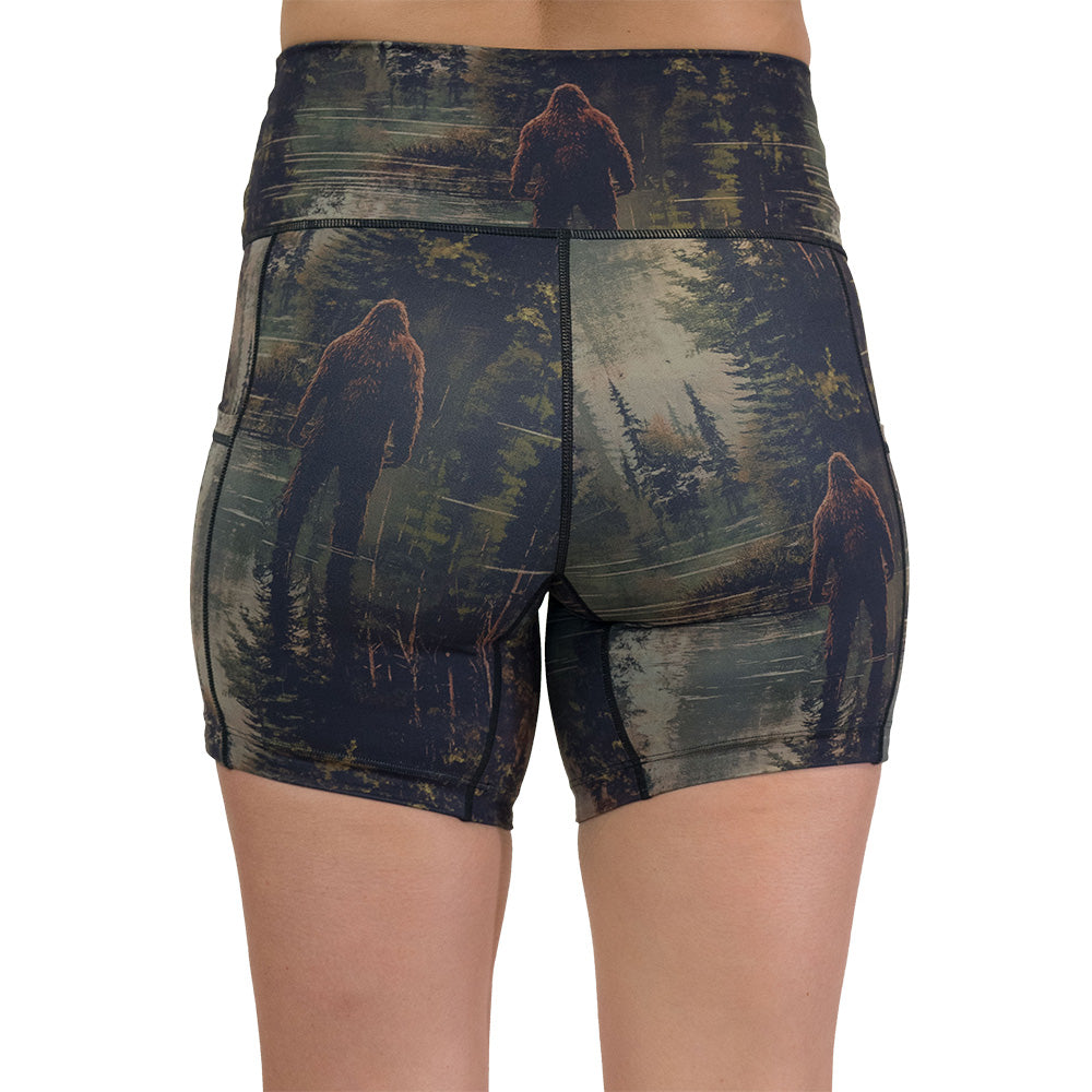 back of the shorts with a forest design and a bigfoot graphic on it