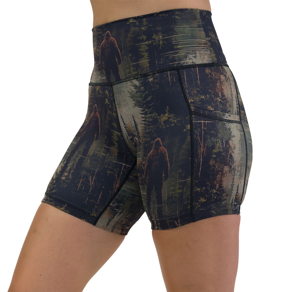 shorts with a forest design and a bigfoot graphic on it