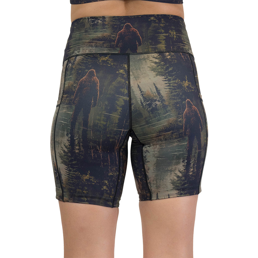 back of the shorts with a forest design and a bigfoot graphic on it