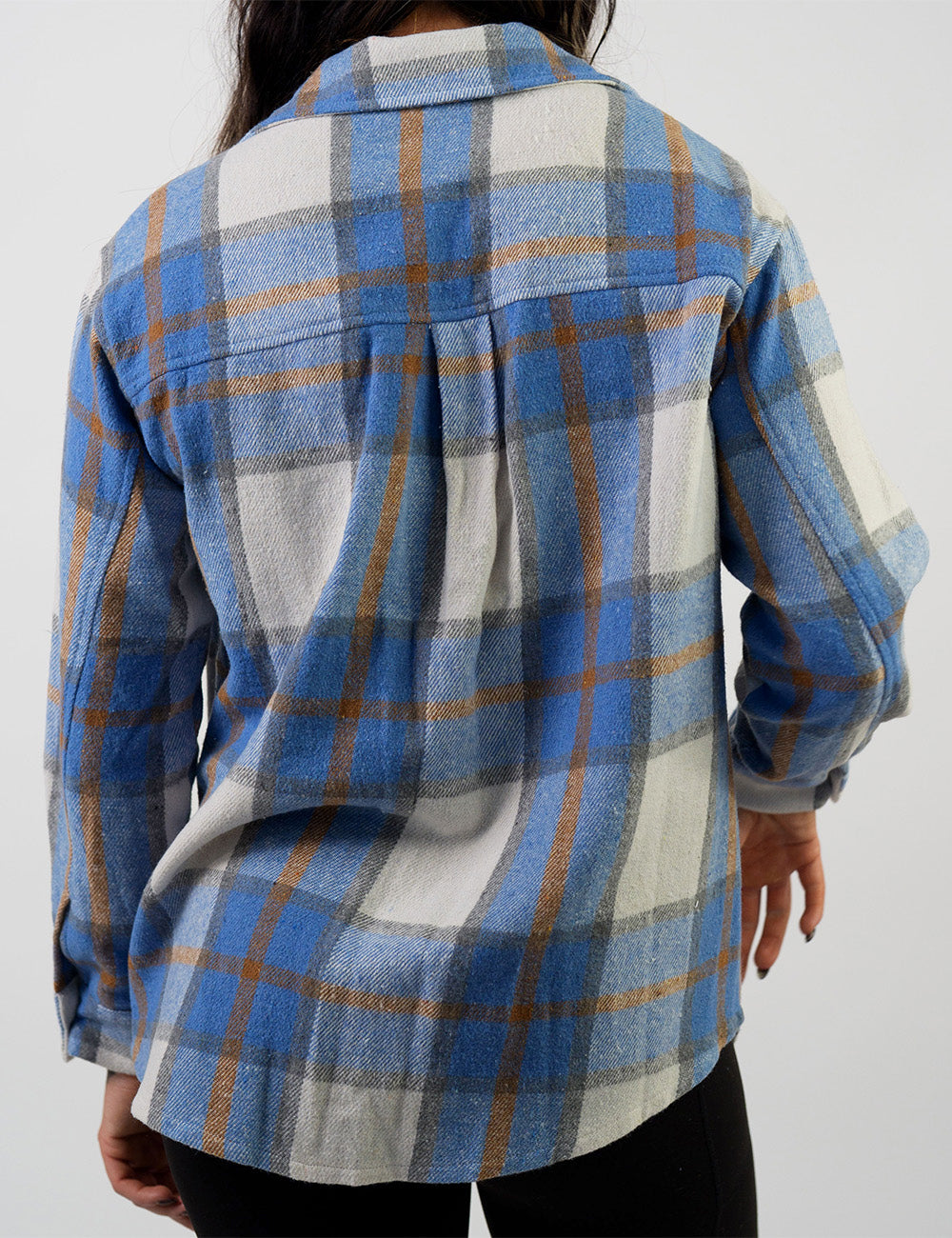 back of the light blue, white, grey, and gold shacket against a white background