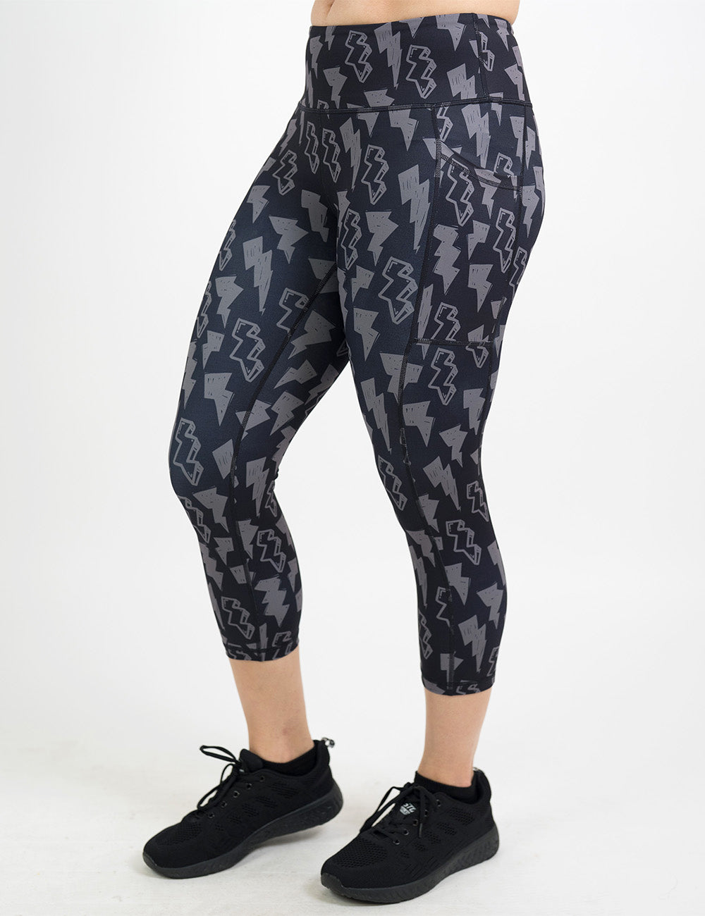 front of the capri black leggings with grey thunder bolts against a white background