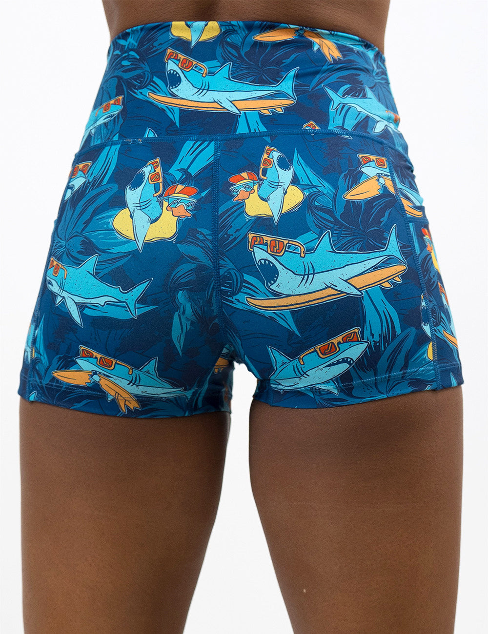 back of the 2.5 inch cartoon sharks surfboarding with sunglasses shorts against a white background