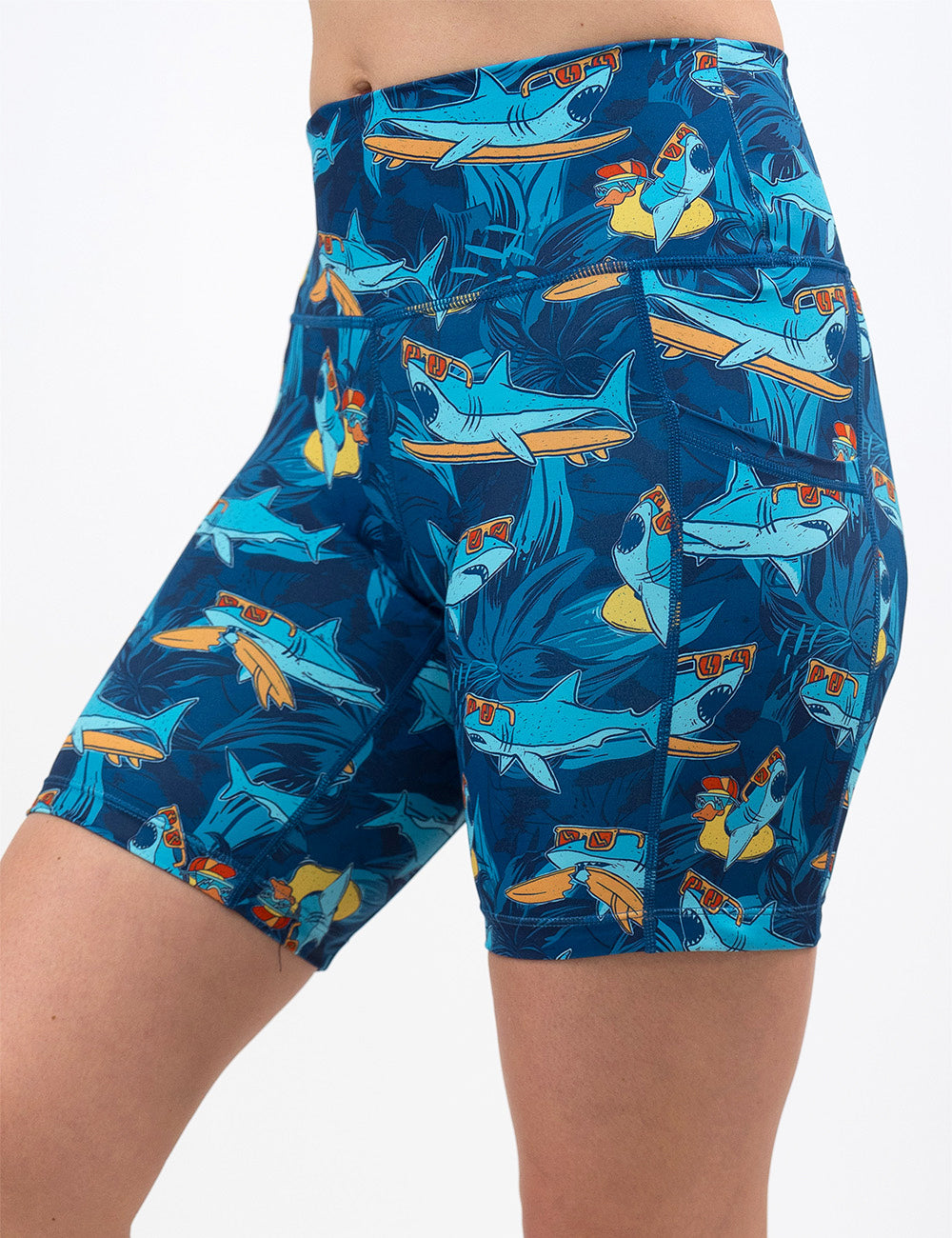 front of the 7 inch cartoon sharks surfboarding with sunglasses shorts against a white background
