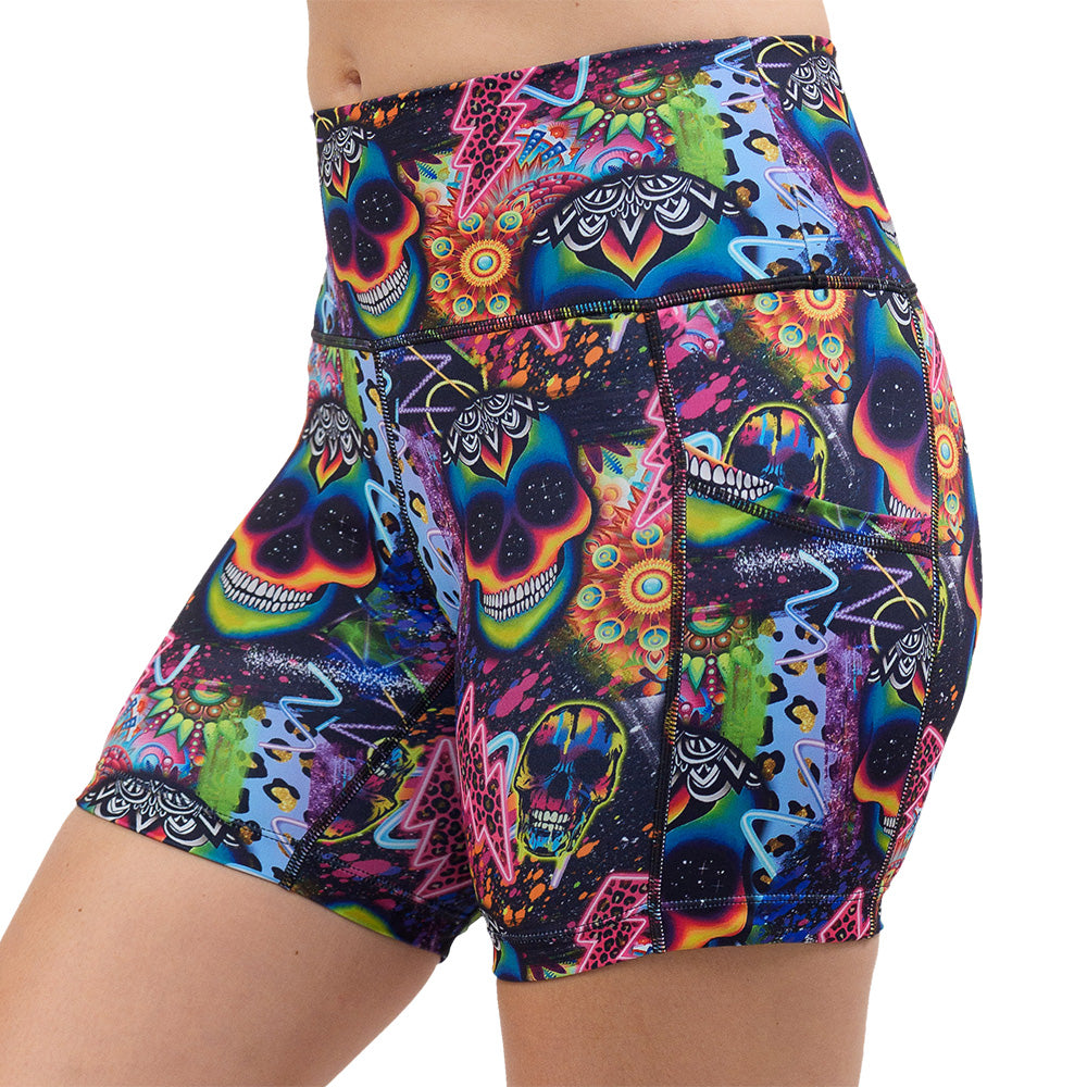 the brightly colored psychedelic skulls pattern against a busy background full of designs 5 inch shorts facing the front against a white background