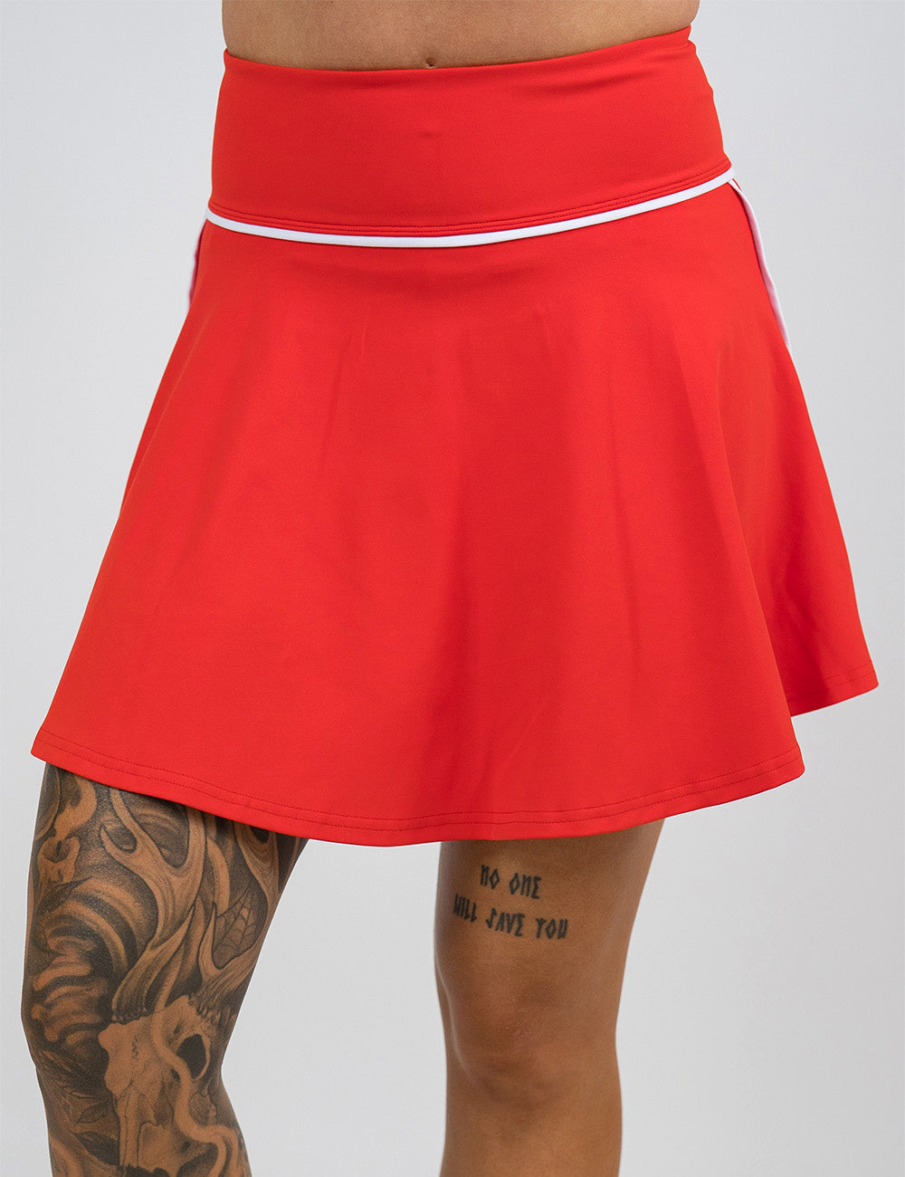 front of the longer length red skirt with white accents against a white background
