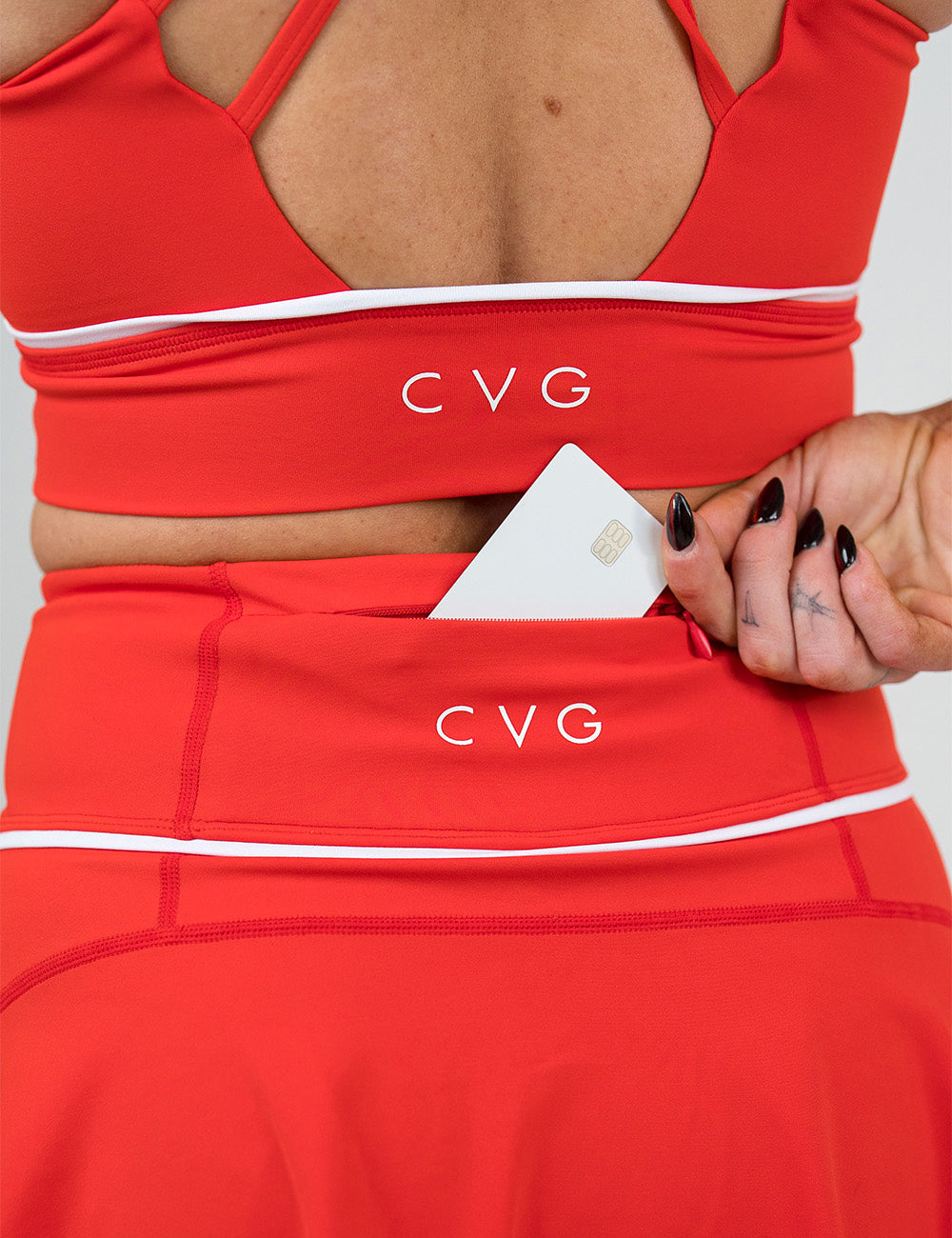 back of the red skirt with white accents with a credit card in its back pocket