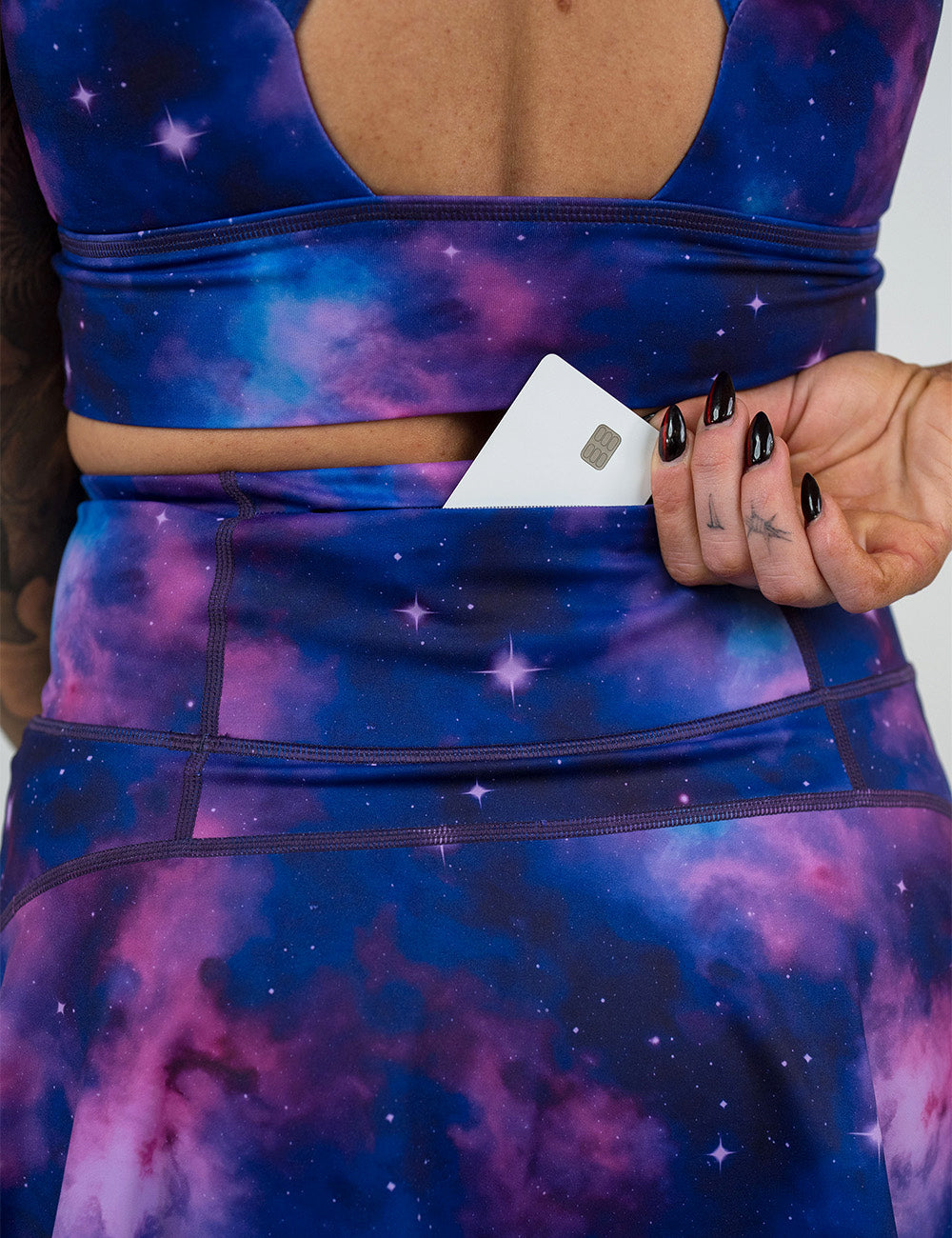 back of the purple and blue space skirt with a credit card in the back pocket against a white background