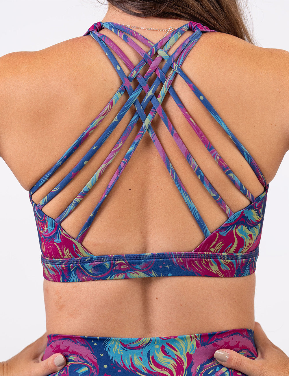 back of the colorful Santa-in-sunglasses sports bra against a white background