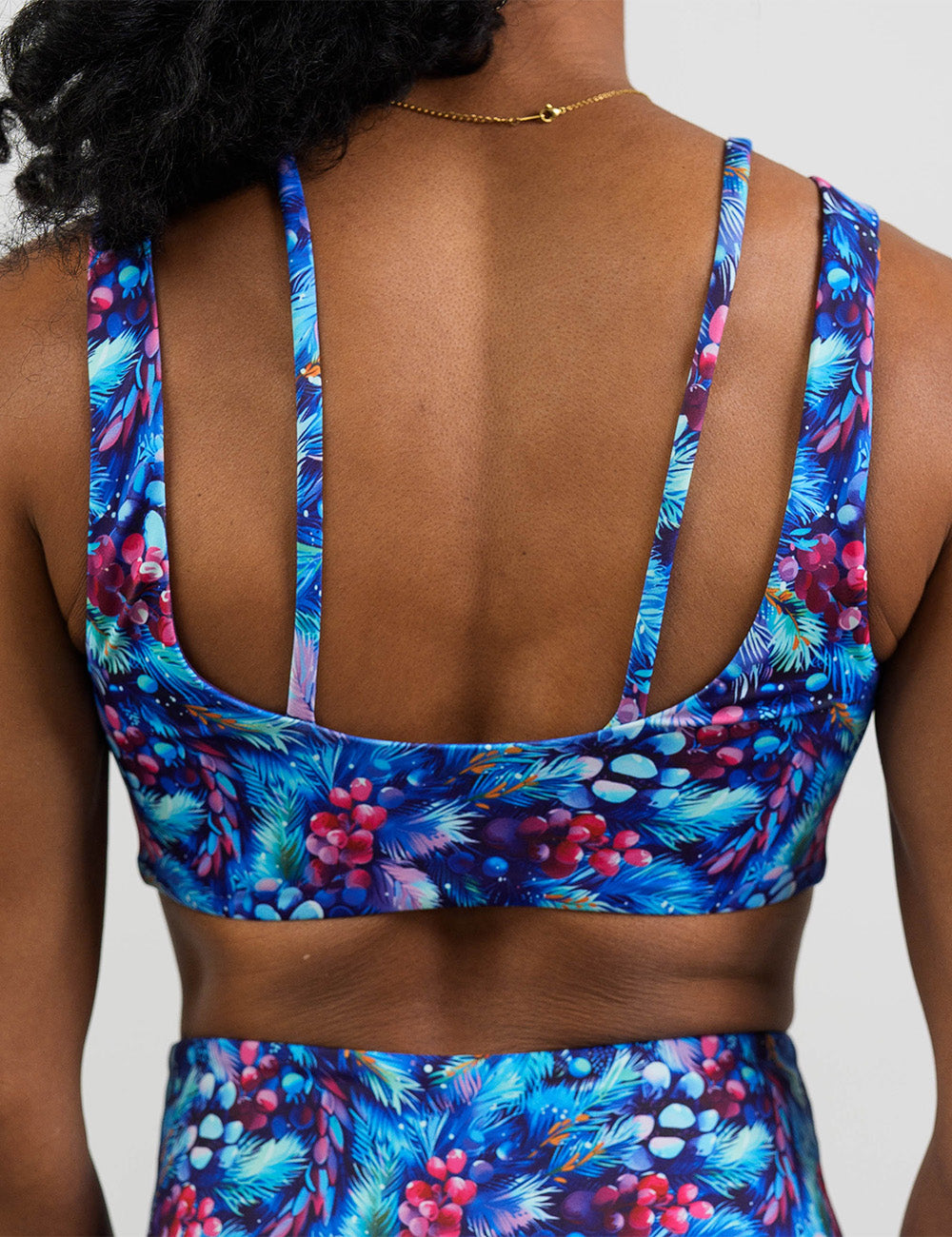 back of the winter berries among blue leaves sports bra