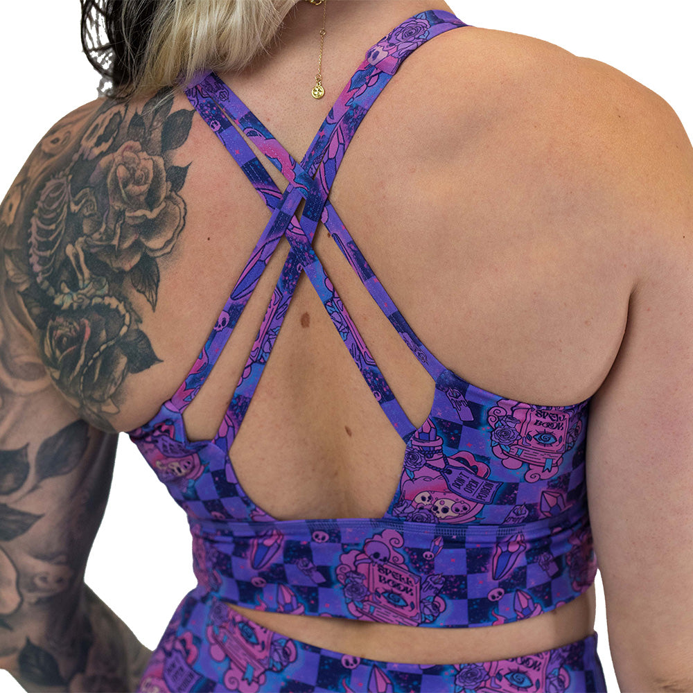 back of the spellbook patterned sports bra