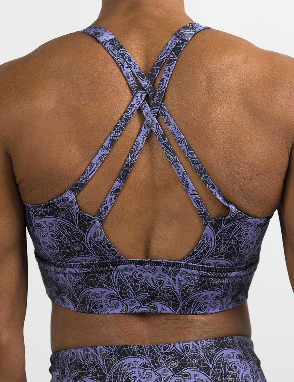 back of the purple bat lace sports bra against a white background