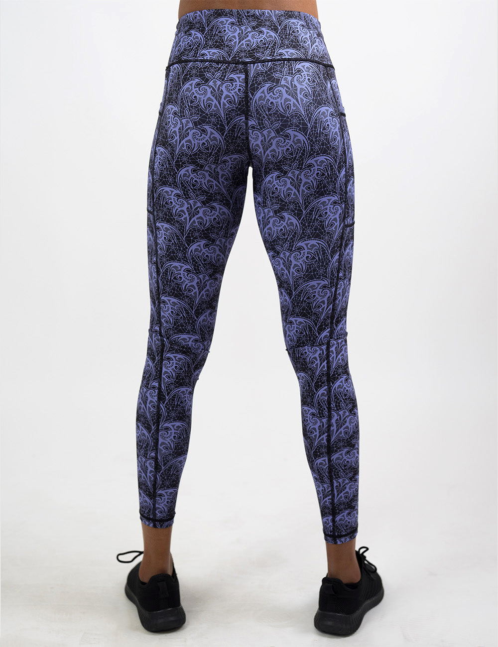 back of the purple lace bats full length leggings against a white background
