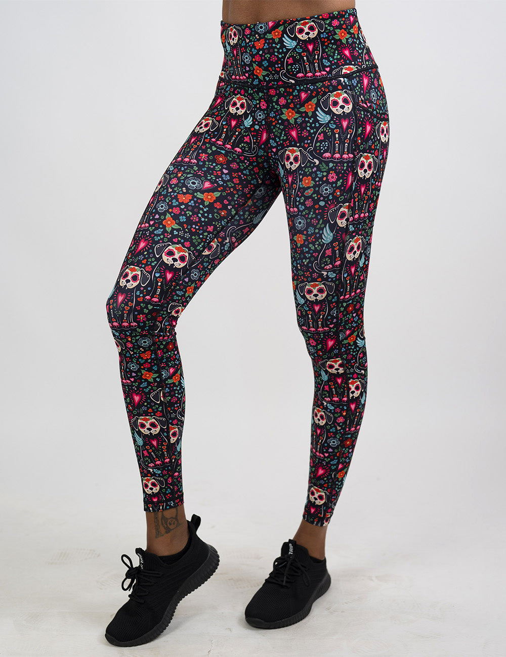 front of the skeleton dogs surrounded by flowers full length leggings against a white background