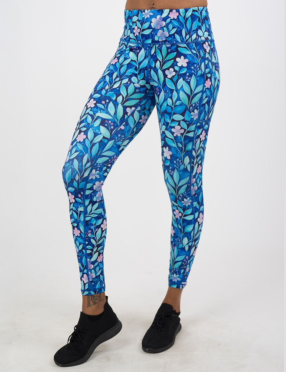 full length blue flowers and vines leggings facing the front against a white background