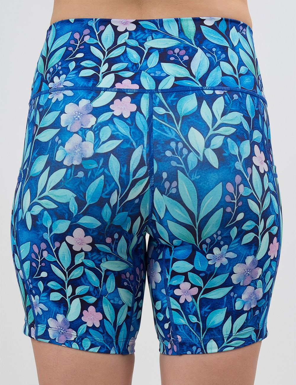 back of the 7 inch blue flowers and vines shorts against a white background