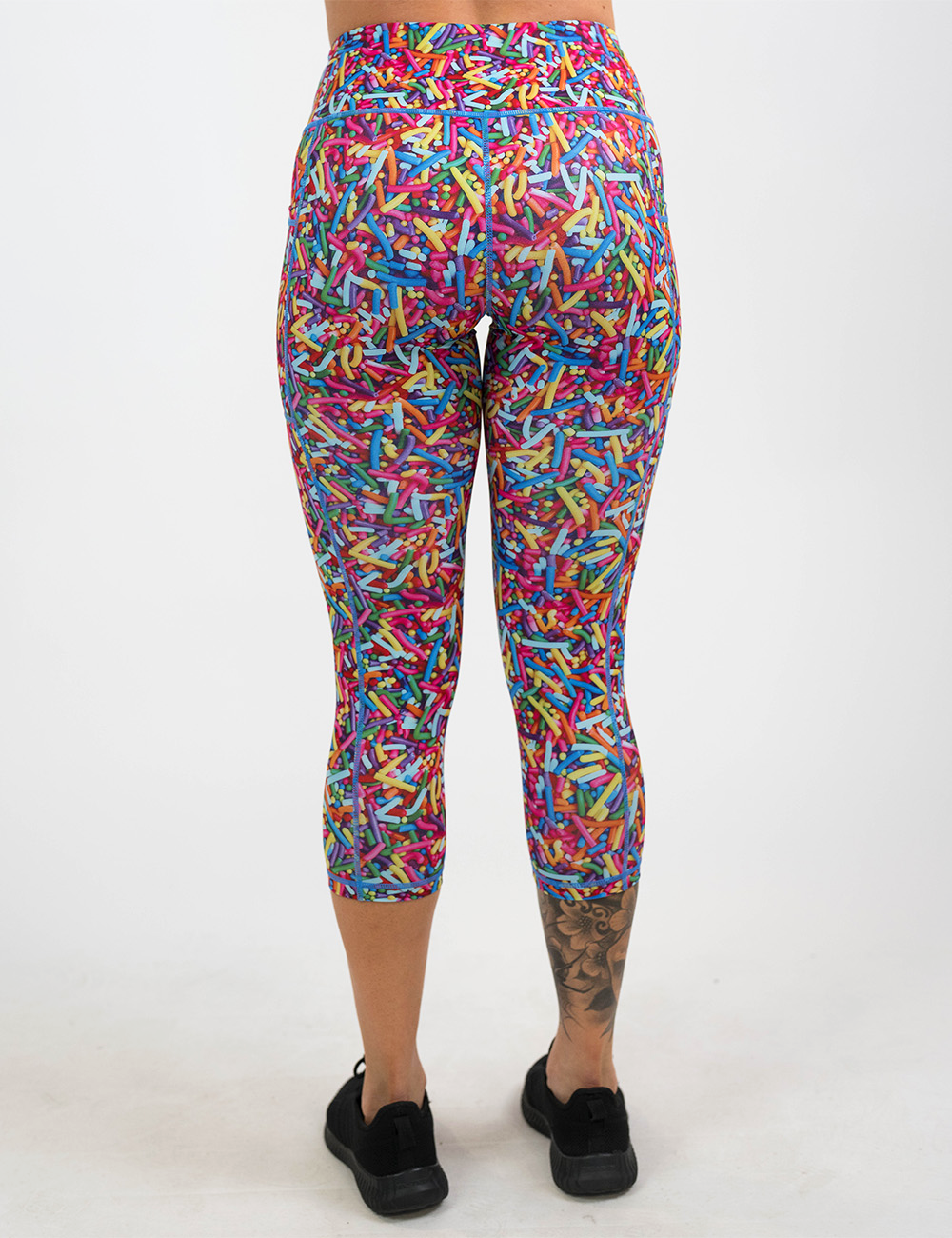 back of the rainbow sprinkles capri leggings against a white background