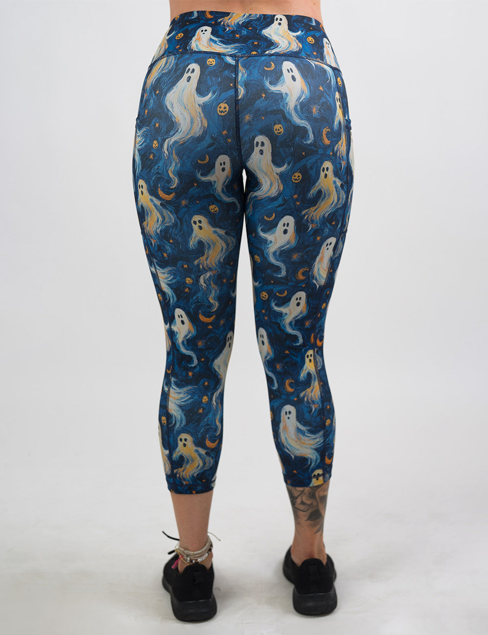 back of the starry night ghosts against a blue background pattern capri leggings against a white background