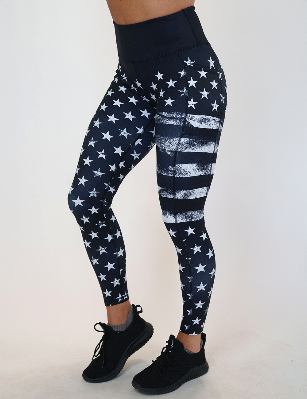 front of the full length black leggings with white American flag design on it against a white background