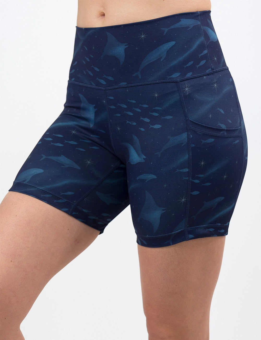 front of the 5 inch dark blue ocean filled with sting rays, whales, and fish shorts against a white background