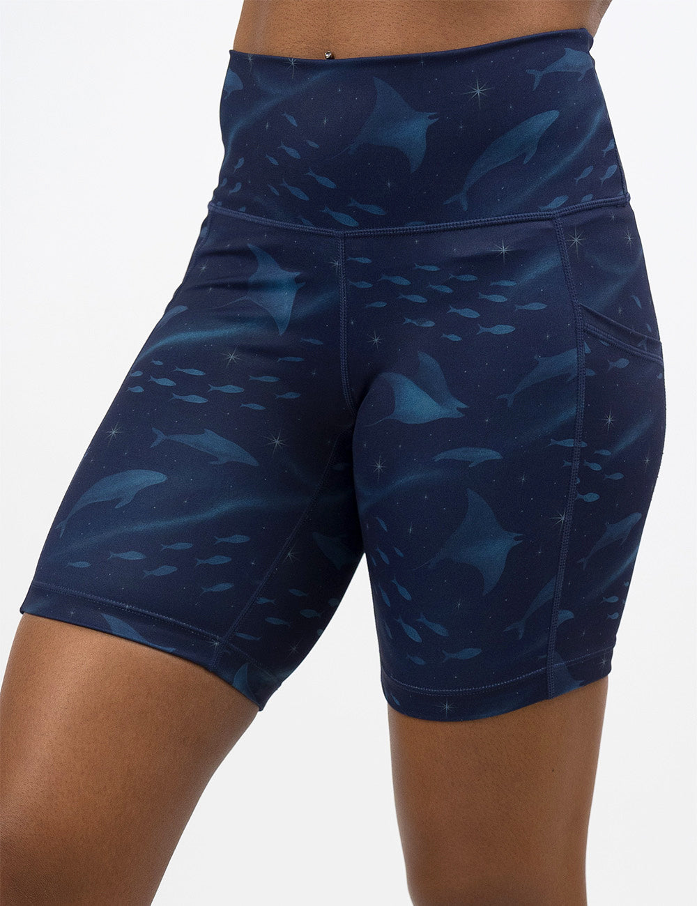 front of the 7 inch dark blue ocean filled with sting rays, whales, and fish shorts against a white background