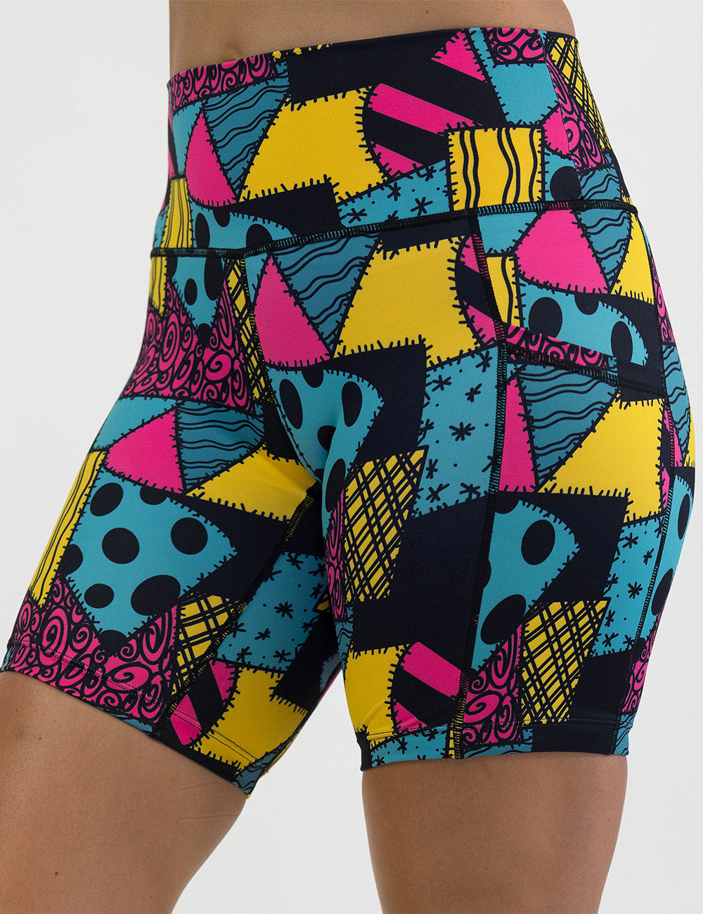 front of the 7 inch yellow, teal, and pink patchwork design shorts against a white background