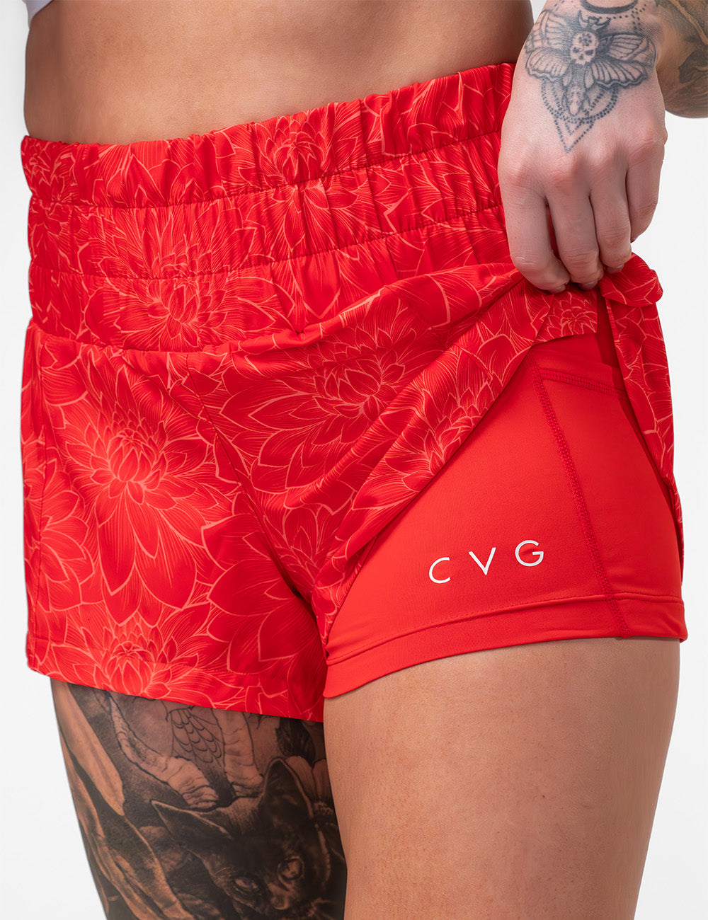 orange lotus day dream shorts pulled up to show the shorts lining with the cvg logo graphic against a white background