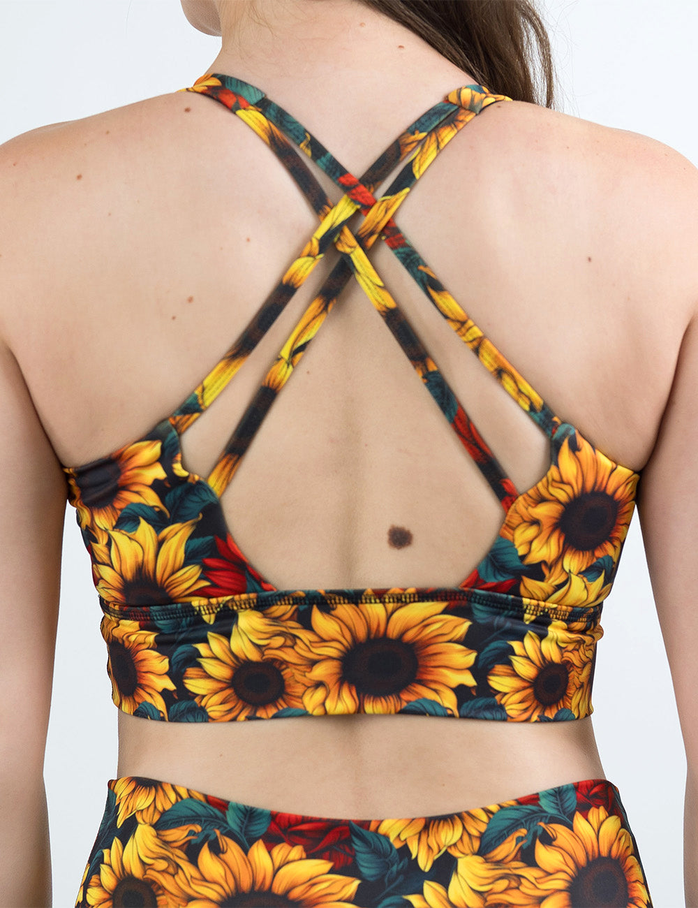 back of the sunflower with red flowers bra against a white background