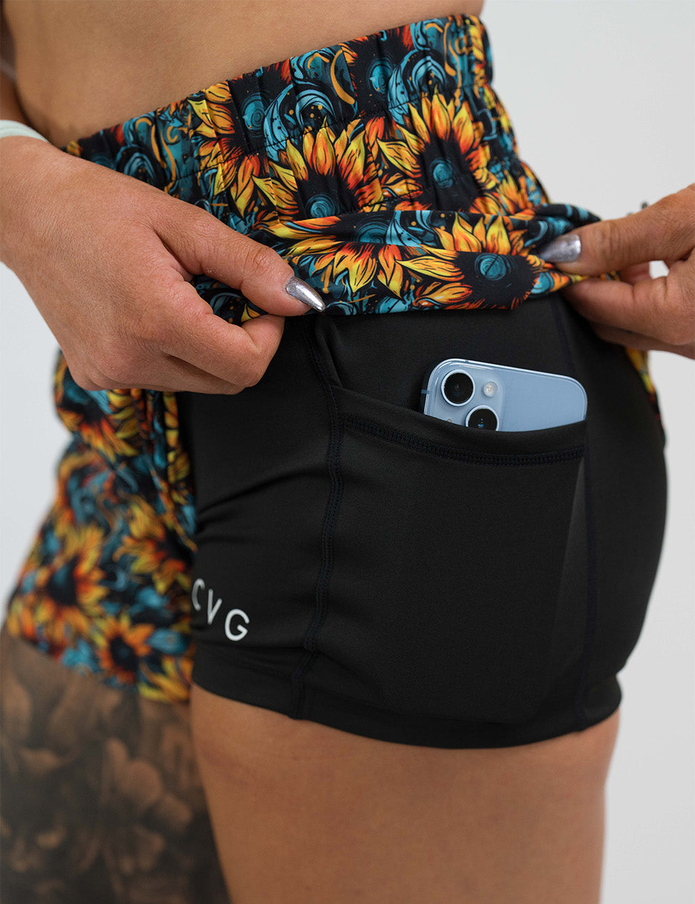 sunflower day dream shorts rolled up to show the pocket with a phone in it against a white background