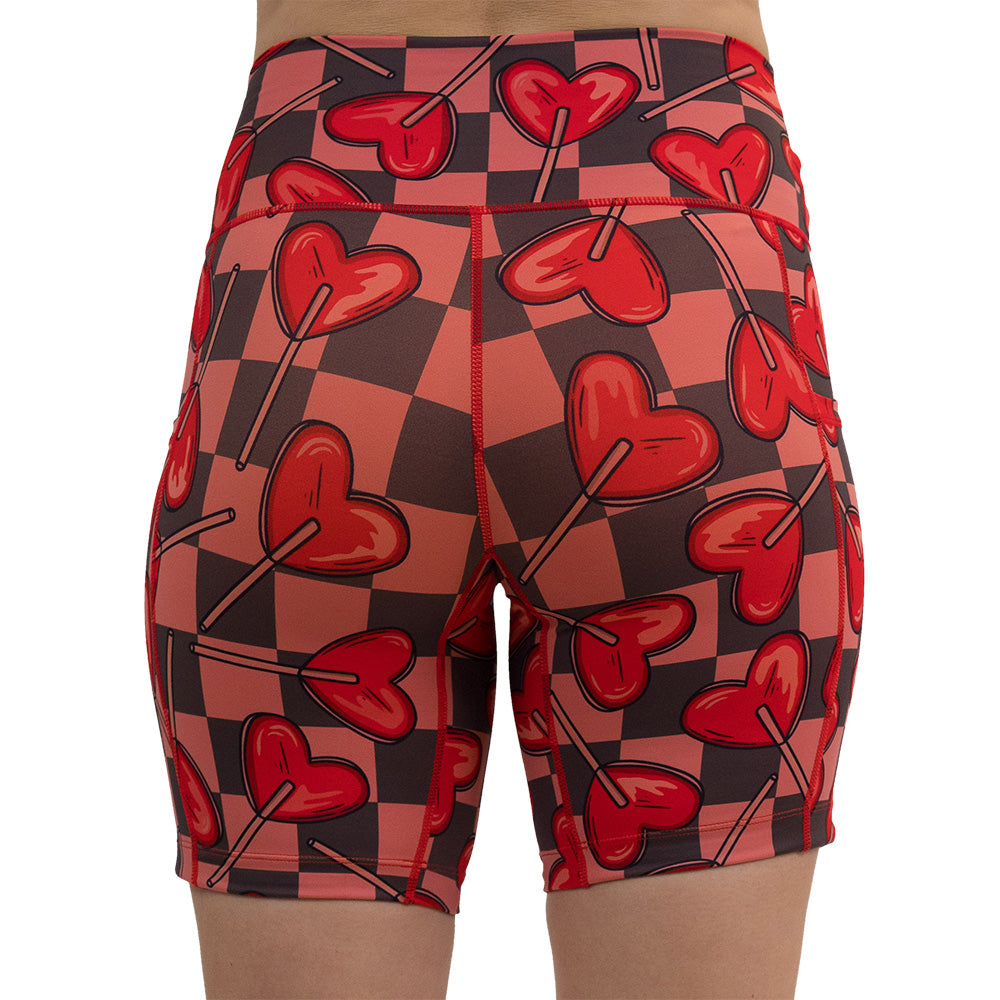 back of the heart lollypops on a checker board pattern 7 inch shorts against a white background