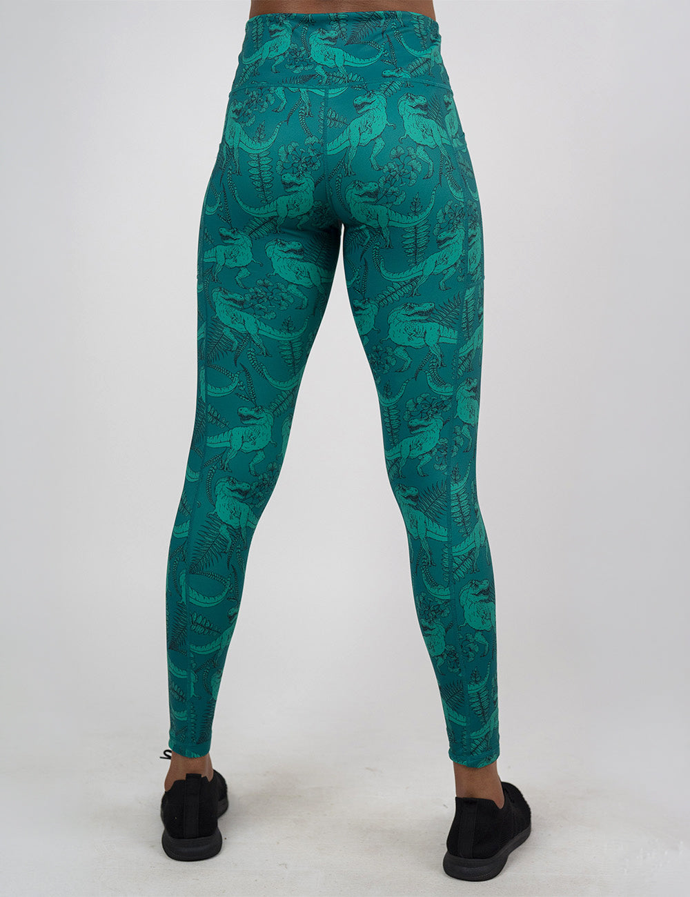 back of the teal t-rex pattern full length leggings against a white background