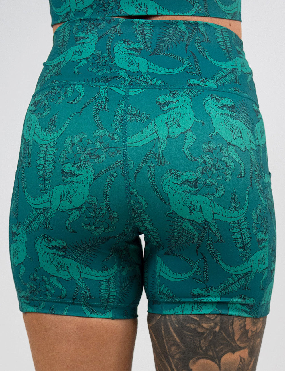 back of the 5 inch teal t-rex shorts against a white background